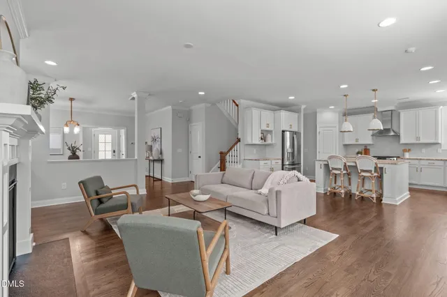 a living room with furniture and kitchen view
