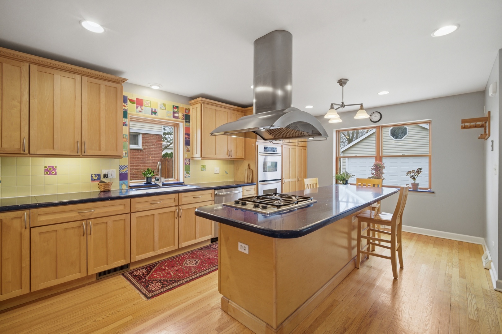 1917 Kiest Avenue Northbrook, IL 60062 - Photo 5 of 27 a kitchen with stainless steel appliances granite countertop a sink a stove and a wooden floors