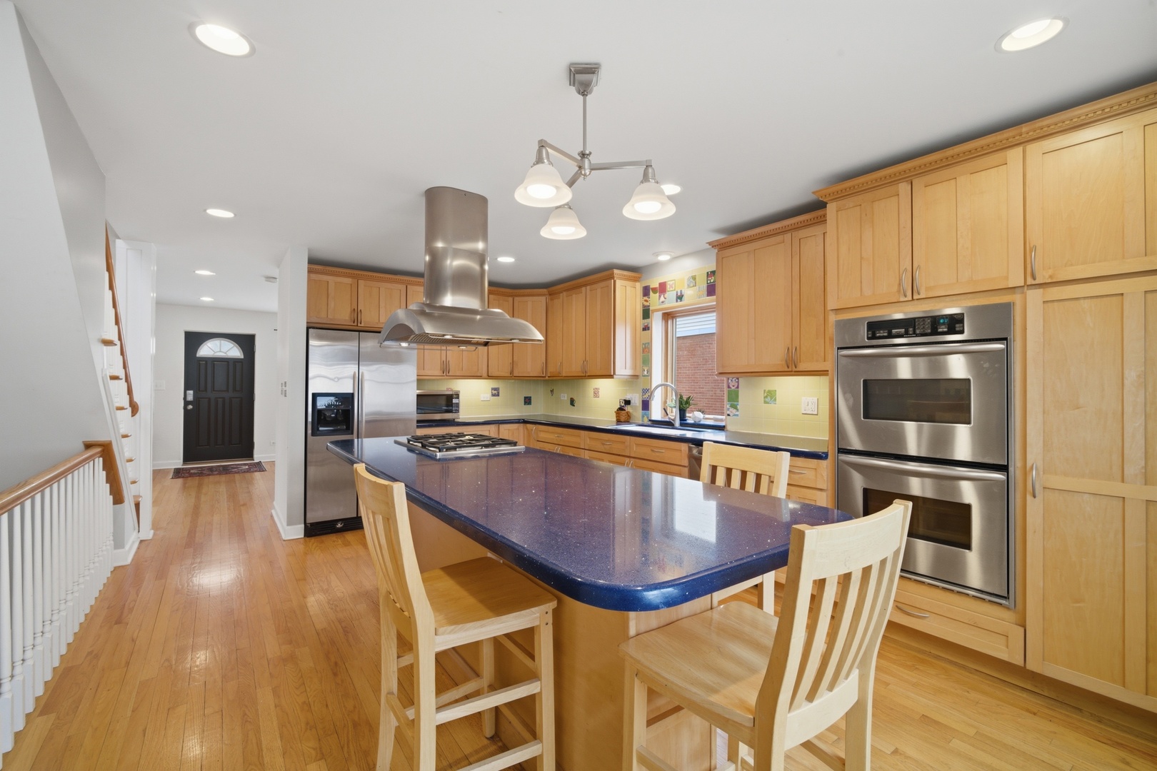 1917 Kiest Avenue Northbrook, IL 60062 - Photo 7 of 27 a kitchen with stainless steel appliances granite countertop a stove a refrigerator a kitchen island a sink a dining table and chairs