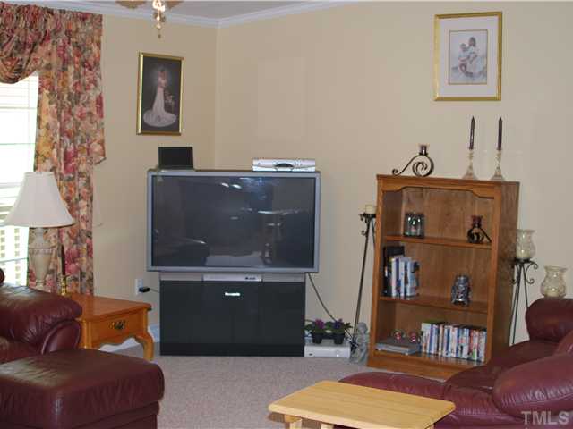 2445 Zacks Mill Road Angier, NC 27501 - Photo 3 of 15 a living room with furniture and a lamp