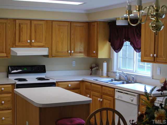 2445 Zacks Mill Road Angier, NC 27501 - Photo 4 of 15 a kitchen with a sink cabinets and window