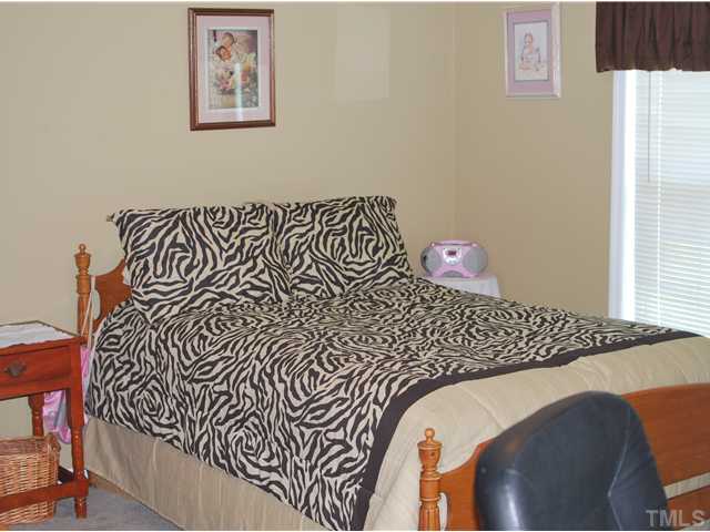 2445 Zacks Mill Road Angier, NC 27501 - Photo 6 of 15 a bedroom with a bed and a window