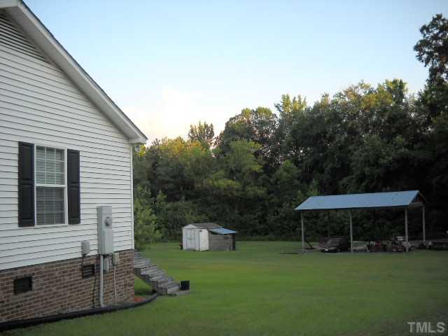 2445 Zacks Mill Road Angier, NC 27501 - Photo 7 of 15 a view of a house with backyard and sitting area