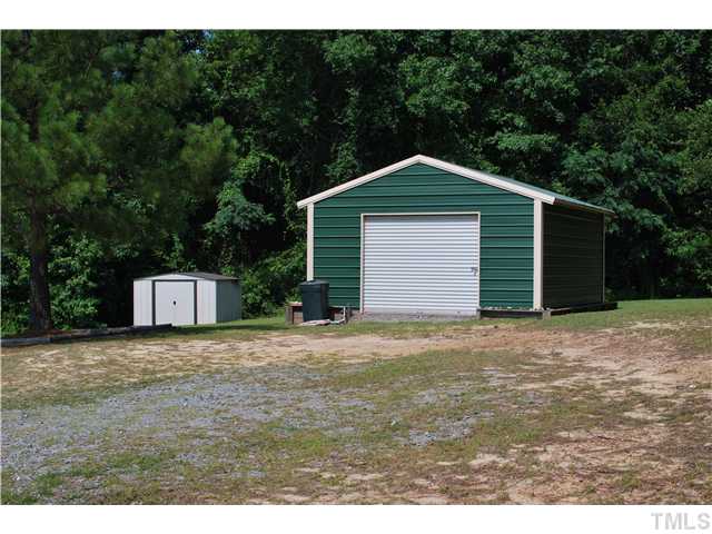 2445 Zacks Mill Road Angier, NC 27501 - Photo 10 of 15 a front view of a house with a yard and garage