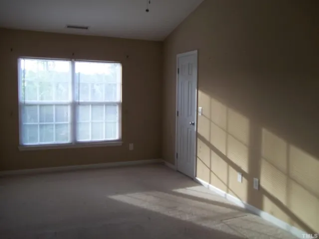 an empty room with a windows