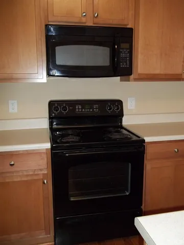 a stove top oven sitting inside of a kitchen