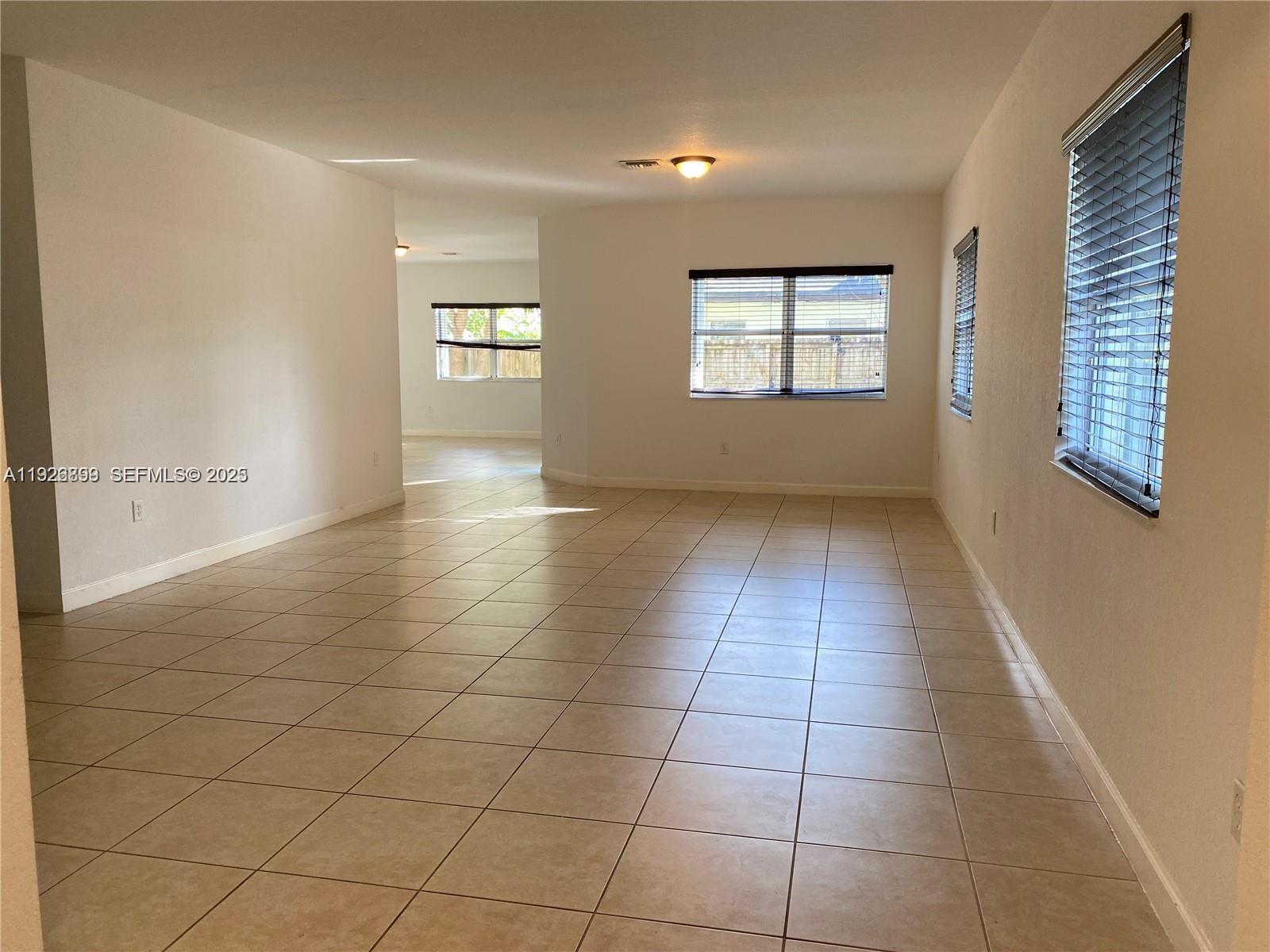 3616 Northeast 3rd Court Homestead, FL 33033 - Photo 2 of 11 an empty room with windows