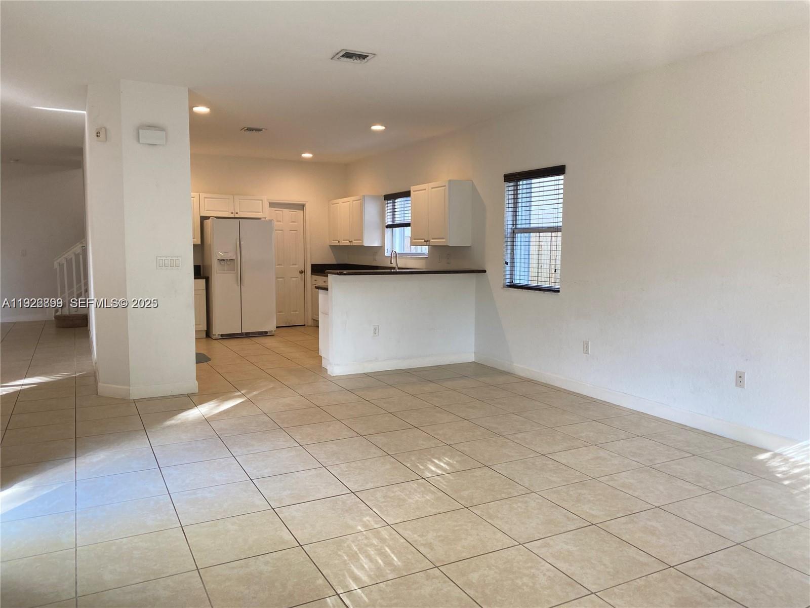 3616 Northeast 3rd Court Homestead, FL 33033 - Photo 5 of 11 a view of a kitchen with a sink and a refrigerator