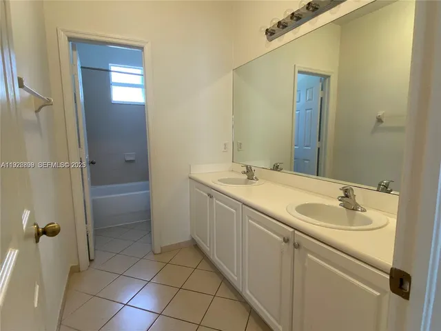 a bathroom with a granite countertop sink a toilet and a mirror
