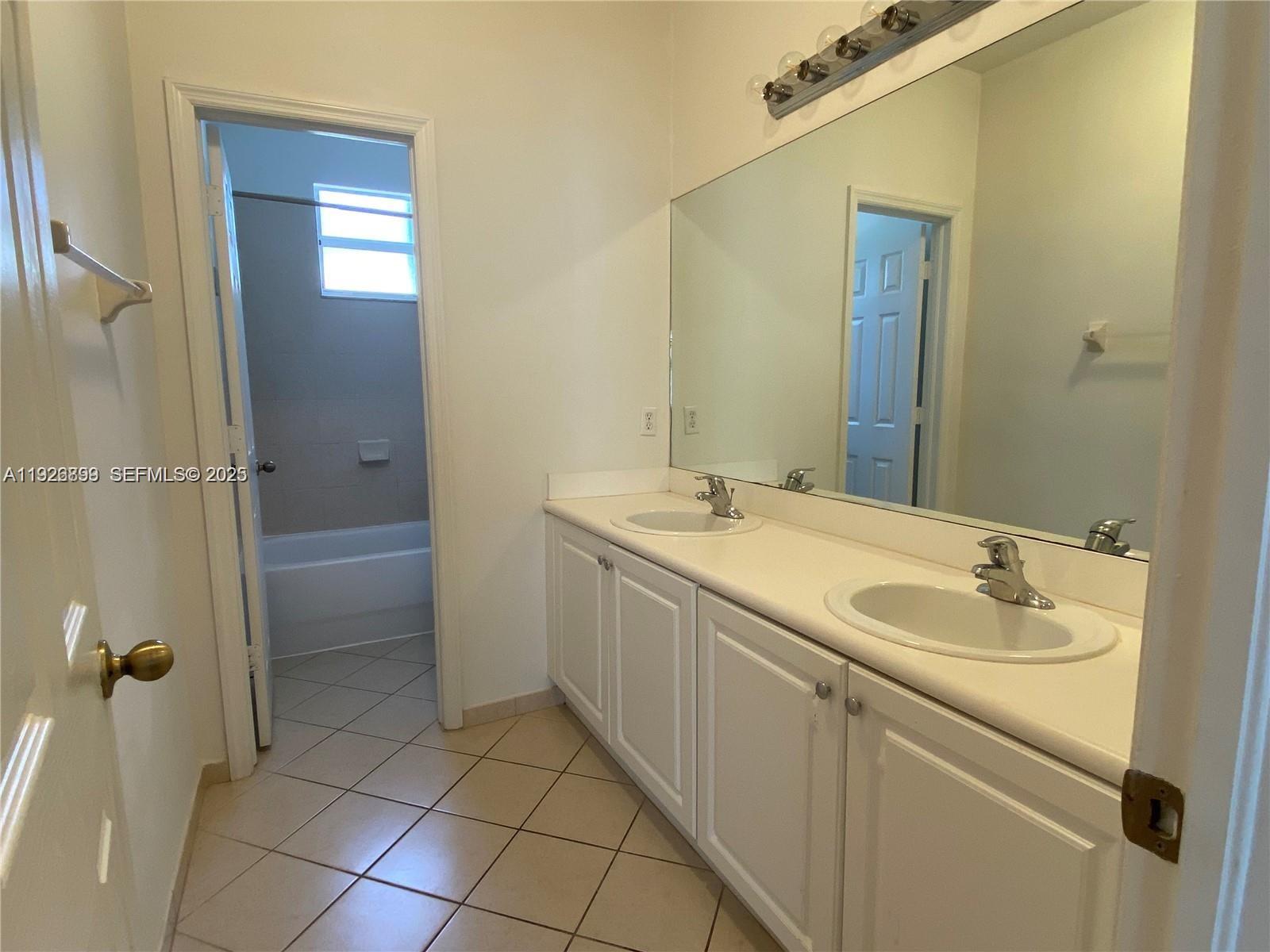 3616 Northeast 3rd Court Homestead, FL 33033 - Photo 8 of 11 a bathroom with a granite countertop sink a toilet and a mirror
