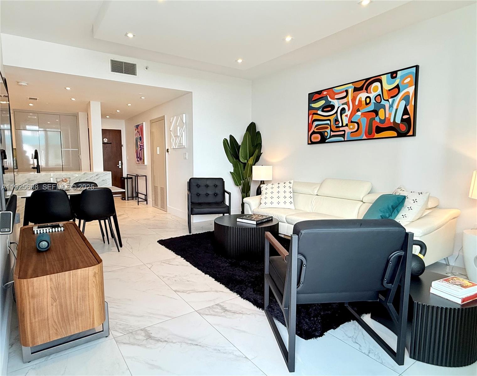 225 Collins Avenue, Unit 6J Miami Beach, FL 33139 - Photo 20 of 49 a living room with furniture and a potted plant