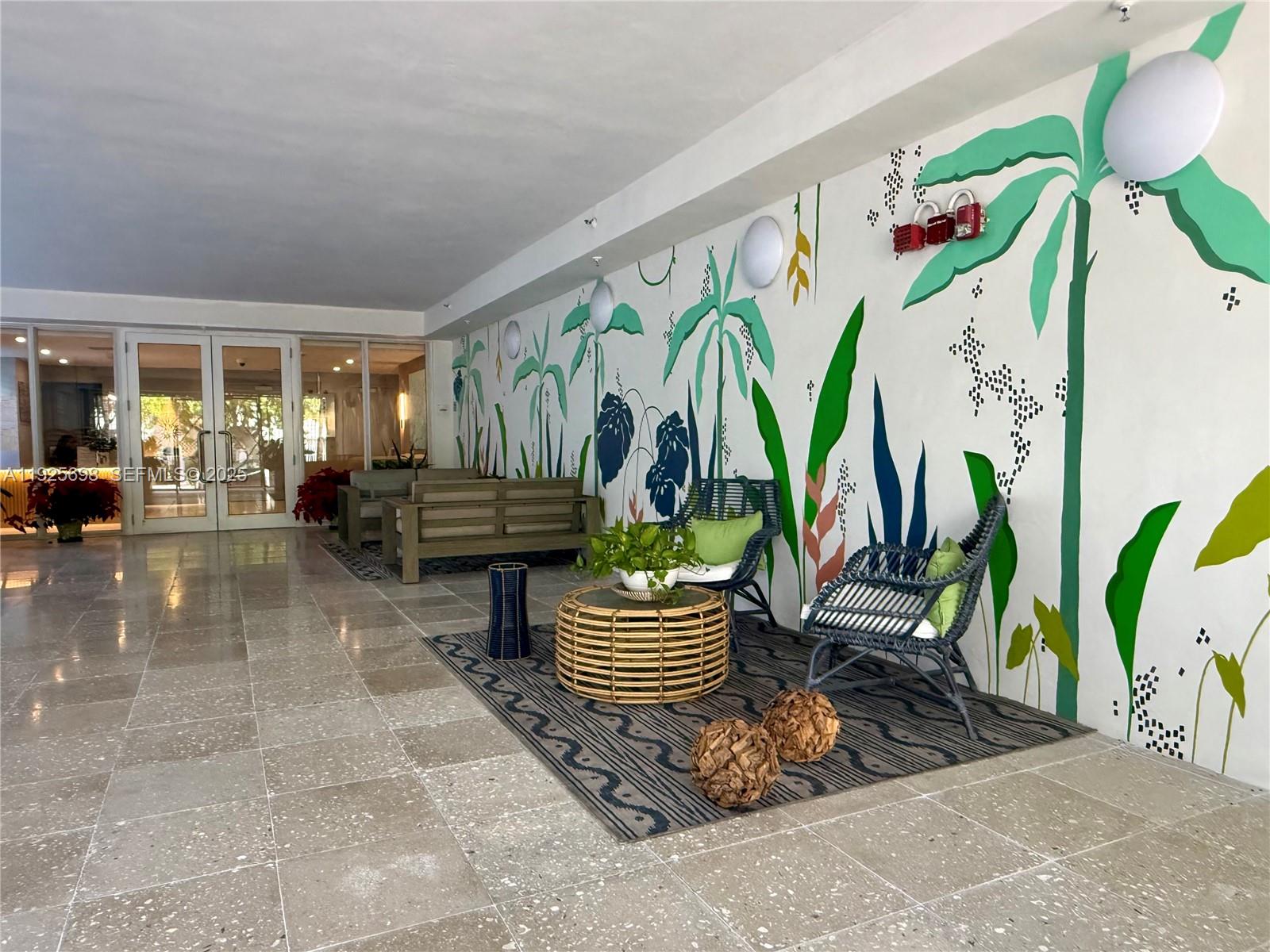 225 Collins Avenue, Unit 6J Miami Beach, FL 33139 - Photo 40 of 49 a living room with patio furniture and a potted plant