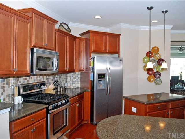 7767 Berry Crest Avenue Raleigh, NC 27617 - Photo 5 of 21 Kitchen w/ Quartz Counters, Stainless Appliances & Hardwoods!