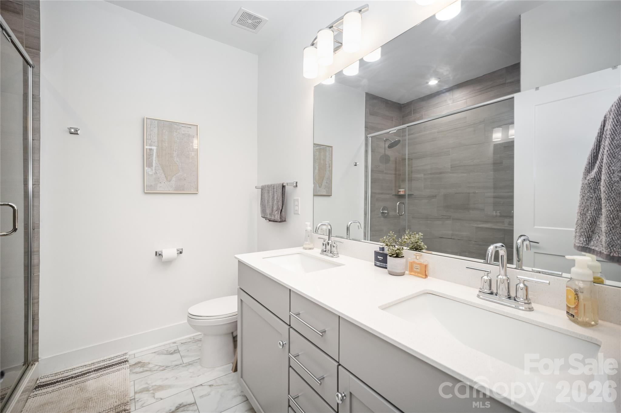 4004 Capital Ridge Charlotte, NC 28205 - Photo 18 of 30 a bathroom with a double vanity sink toilet and a mirror