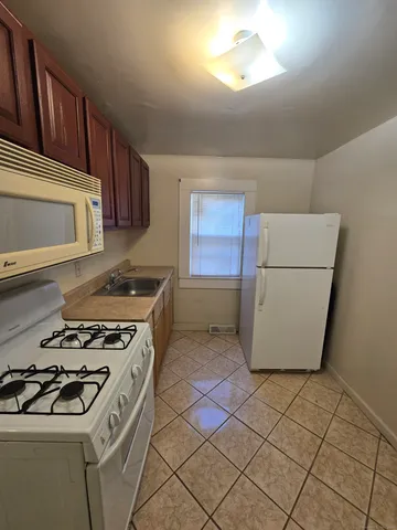 a kitchen with a stove a refrigerator and a sink