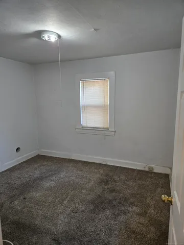 an empty room with a empty space and windows