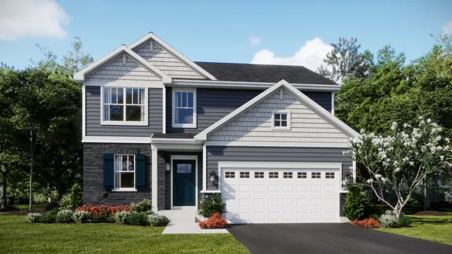 a view of a white house with a small yard plants and large tree