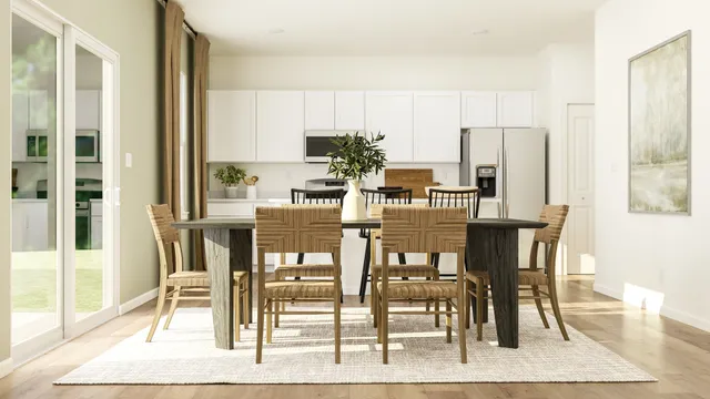 a view of a dining room with furniture and wooden floor