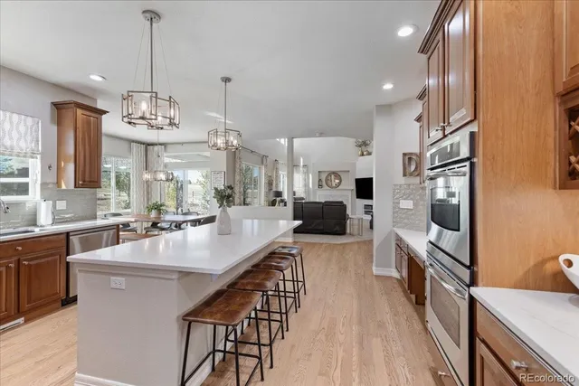 a large kitchen with kitchen island granite countertop a island in the center and stainless steel appliances