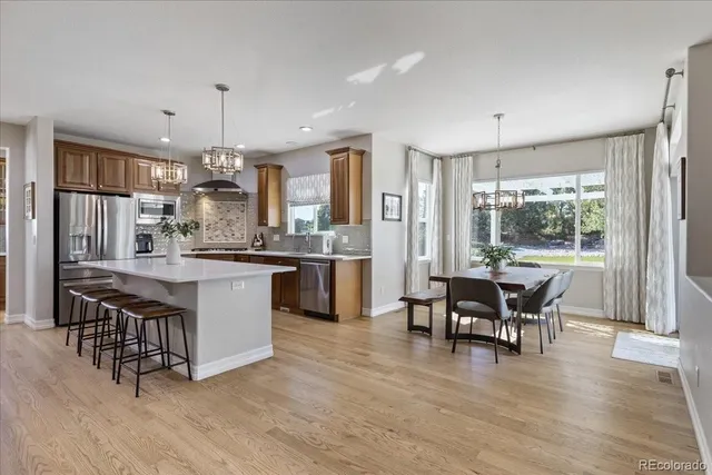a large kitchen with a table and chairs