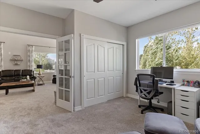 a livingroom with workspace and a window