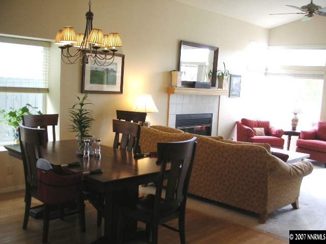 6338 Golden Creek Road Reno, NV 89519 - Photo 5 of 9 a living room with furniture a chandelier and a fireplace