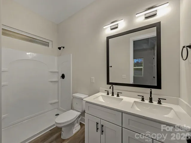 a view of a yard in front of a house with a large tree