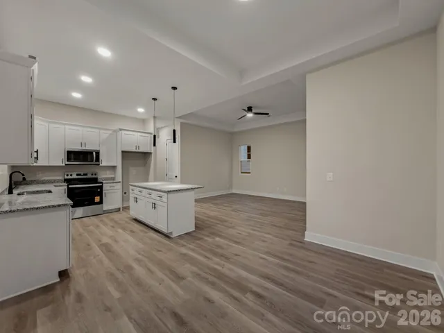 a kitchen with stove cabinets and wooden floor