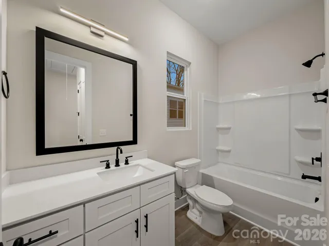 a bathroom with a sink toilet tub and shower