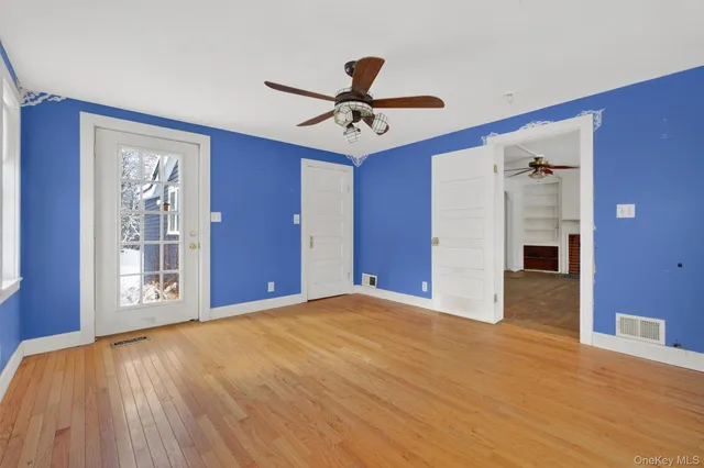 a view of empty room with wooden floor