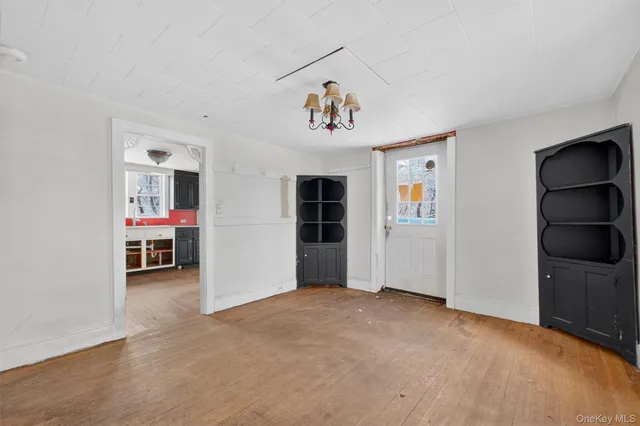 a view of livingroom with hardwood floor and cabinet
