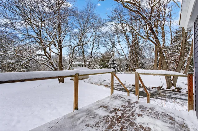 a view of a covered with snow in middle of the road