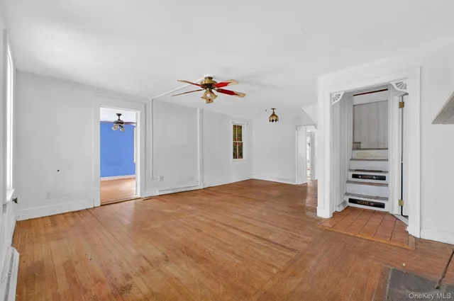 a view of a livingroom with a fireplace a ceiling fan and fireplace