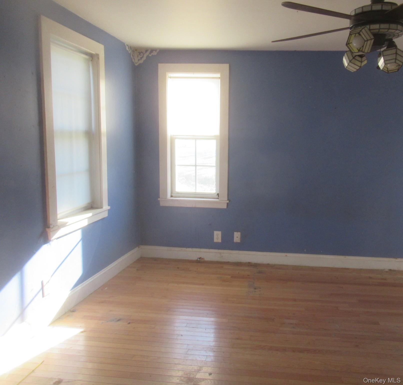 91 Clove Branch Road Hopewell Junction, NY 12533 - Photo 6 of 8 a view of an empty room with wooden floor and a window