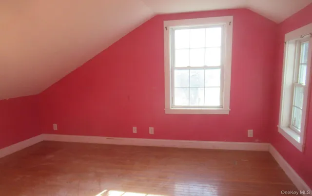 a view of a room with wooden floor and windows