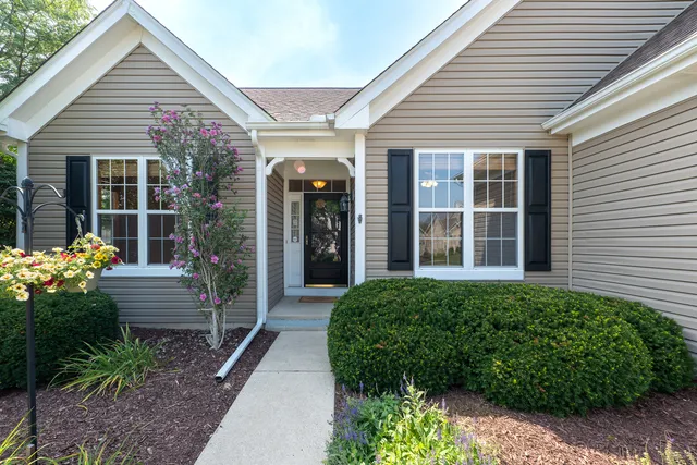 a front view of house with yard and green space
