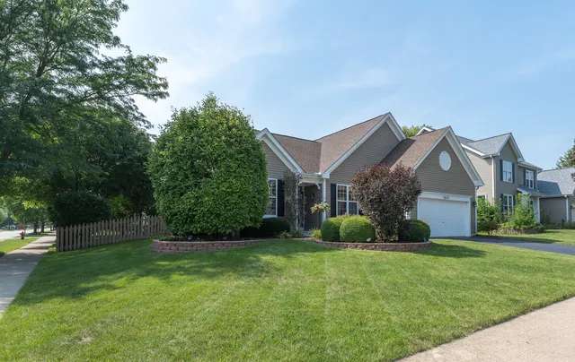 a view of a house with a yard and basketball court
