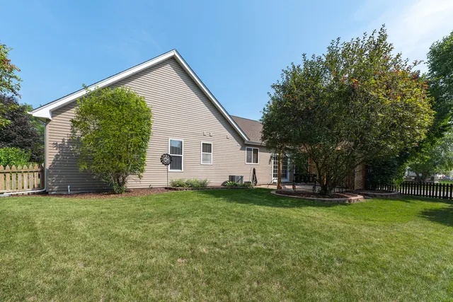 a view of a patio with a table chairs and a yard