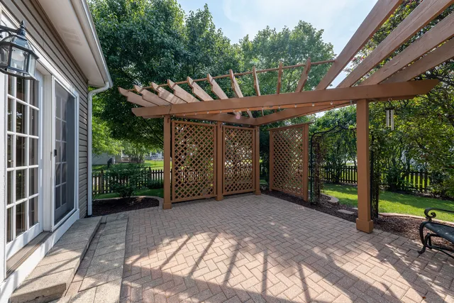 a backyard of a house with fountain and outdoor seating