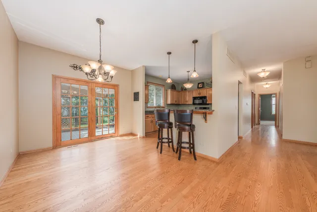 a view of a room with wooden floor and windows