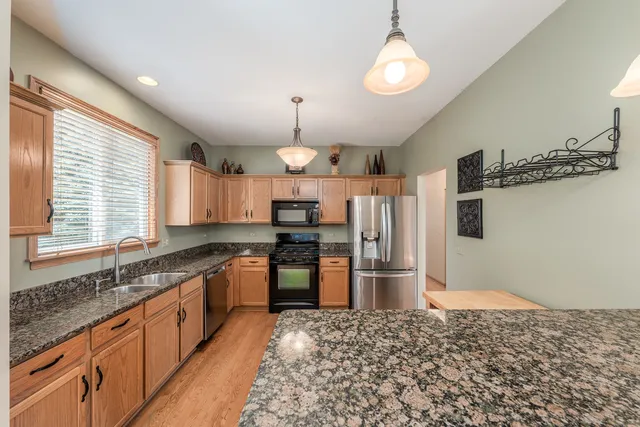 a kitchen with refrigerator and cabinets