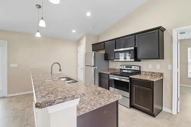 a stove top oven sitting inside of a kitchen
