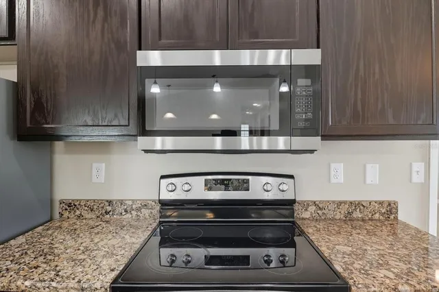 a bathroom with a sink a vanity and a large mirror