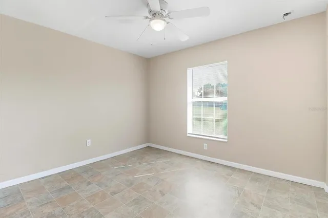 an empty room with a ceiling fan