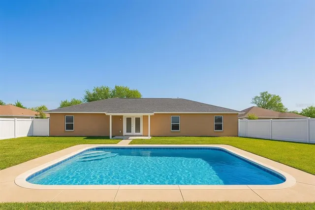 an aerial view of multiple houses with yard