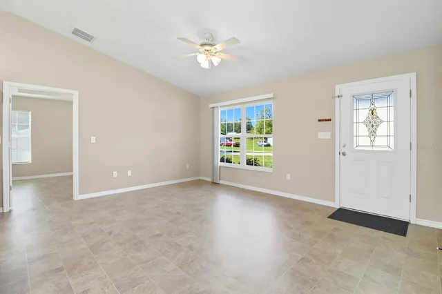 a view of a kitchen with a refrigerator a microwave and a sink