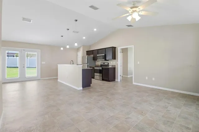 a view of kitchen with furniture and stainless steel appliances