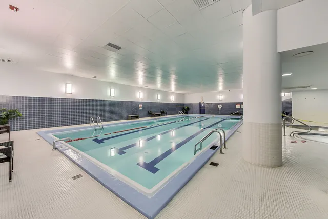 a view of a swimming pool with outdoor seating