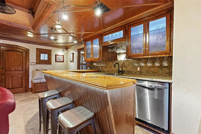 a view of a kitchen with stainless steel appliances granite countertop a sink and cabinets