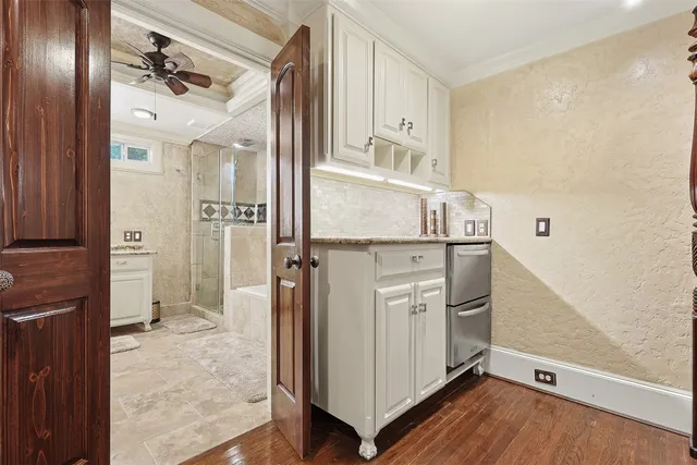 view of hall way with wooden floor and cabinets